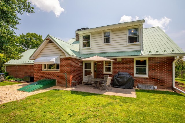 7035 Scenic Dr, Bloomsburg, PA 17815 - back of house with brick siding, a lawn, a patio, and a metal roof