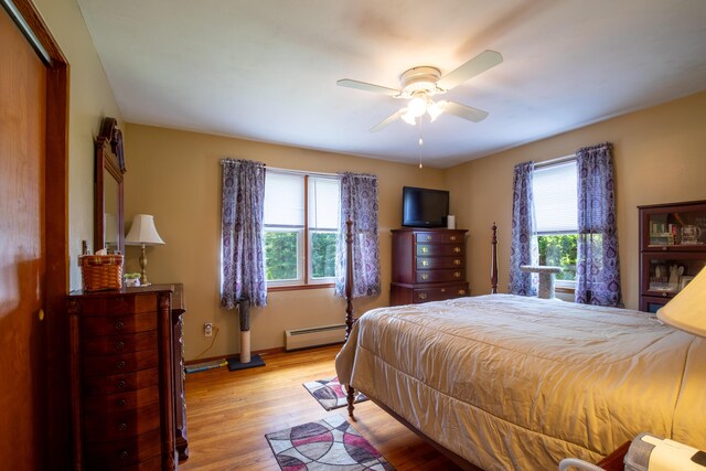 7035 Scenic Dr, Bloomsburg, PA 17815 - bedroom with baseboard heating, light wood-type flooring, and a ceiling fan