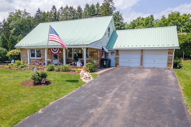 7035 Scenic Dr, Bloomsburg, PA 17815 - view of front of property with stone siding, a front yard, an attached garage, and a metal roof