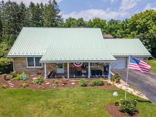 7035 Scenic Dr, Bloomsburg, PA 17815 - a-frame home featuring covered porch, a front lawn, stone siding, and asphalt driveway