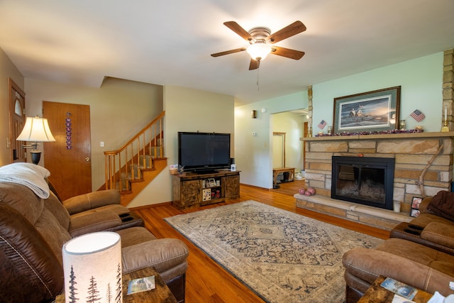 7035 Scenic Dr, Bloomsburg, PA 17815 - living area with ceiling fan, wood finished floors, stairway, and a fireplace