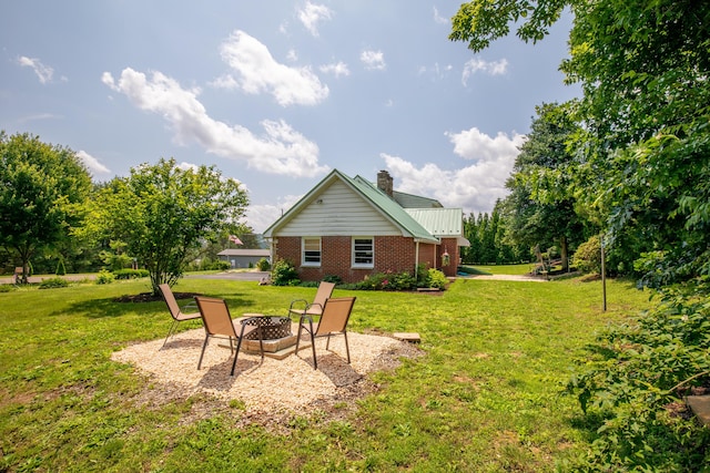 7035 Scenic Dr, Bloomsburg, PA 17815 - back of house with brick siding, a chimney, a lawn, and a fire pit