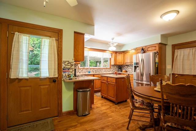 7035 Scenic Dr, Bloomsburg, PA 17815 - kitchen with stainless steel refrigerator with ice dispenser, a ceiling fan, light wood-type flooring, and tasteful backsplash