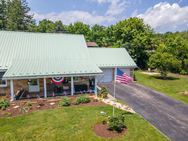 7035 Scenic Dr, Bloomsburg, PA 17815 - a-frame home with stone siding, a porch, a front yard, and a metal roof