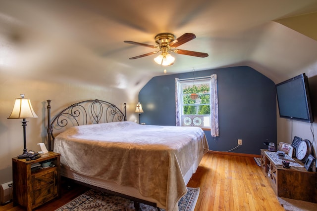 7035 Scenic Dr, Bloomsburg, PA 17815 - bedroom with hardwood / wood-style floors, lofted ceiling, a baseboard heating unit, and a ceiling fan