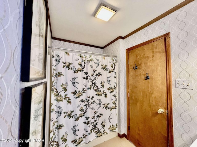 bathroom with crown molding, a shower with shower curtain, and wallpapered walls