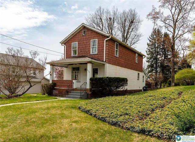traditional-style house with a porch and a front yard