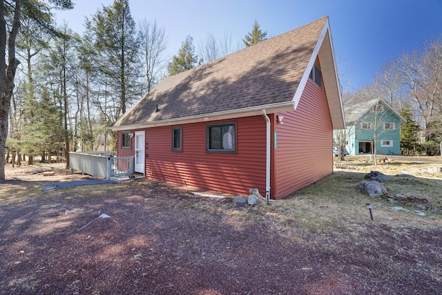 view of property exterior featuring roof with shingles