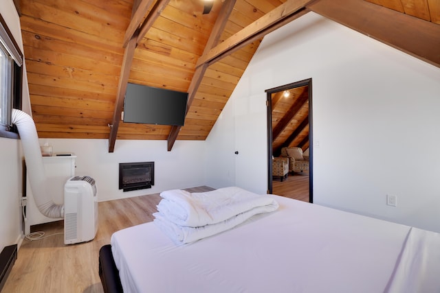 bedroom with a glass covered fireplace, wooden ceiling, lofted ceiling with beams, and wood finished floors