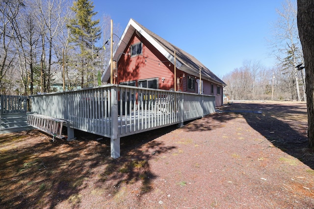 rear view of property featuring a deck