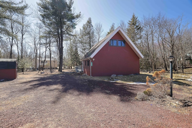 view of side of home with driveway