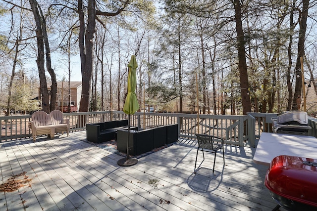 wooden deck featuring grilling area and an outdoor hangout area