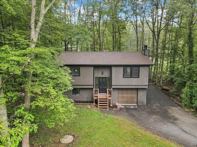 148 Acorn Ln, Kunkletown, PA 18058 - raised ranch featuring a chimney, roof with shingles, asphalt driveway, and an attached garage