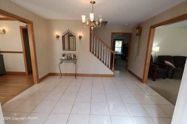 interior space featuring stairs, light tile patterned floors, baseboards, and wallpapered walls