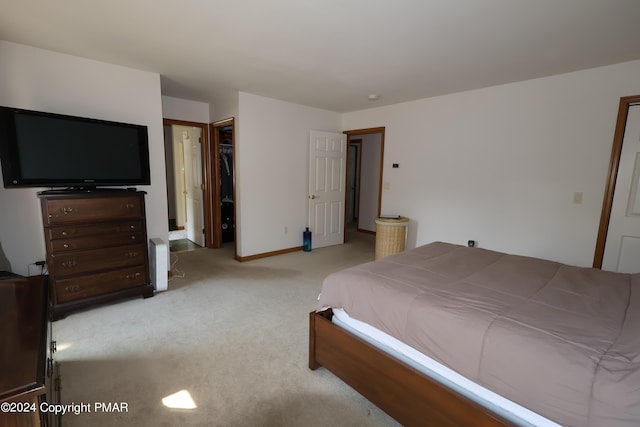 bedroom with carpet, baseboards, and a closet