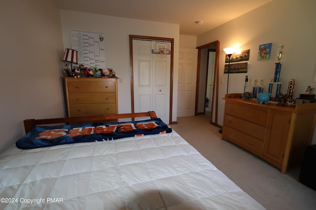 bedroom with a closet and light colored carpet