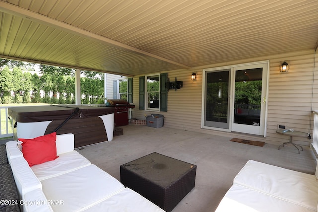 view of patio featuring outdoor lounge area, a hot tub, and grilling area