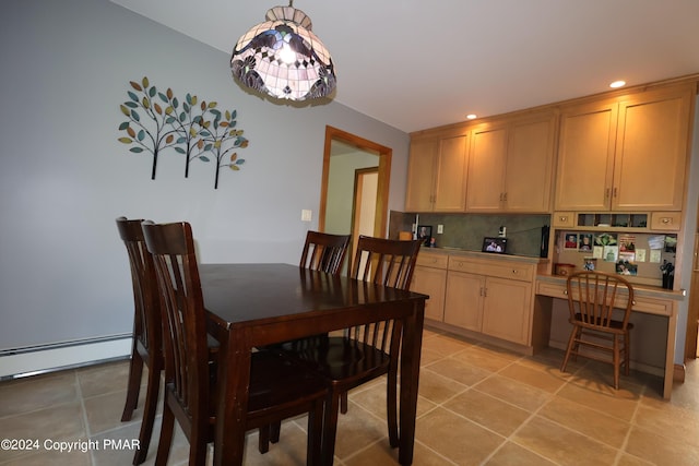 dining space with recessed lighting, a baseboard radiator, built in desk, and light tile patterned flooring