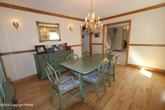 dining room featuring a notable chandelier, wallpapered walls, ornamental molding, and light wood-style floors