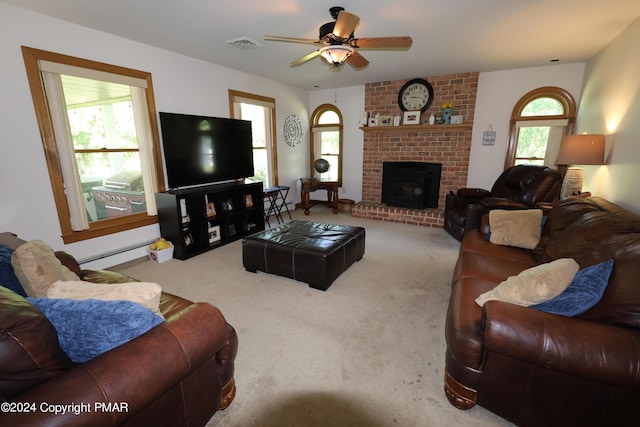 living room with a baseboard heating unit, carpet, visible vents, and plenty of natural light