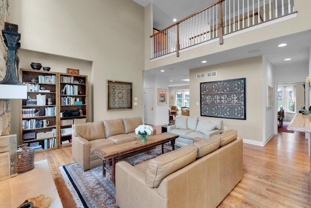 117 Morning Side Ter, East Stroudsburg, PA 18302 - living room featuring a high ceiling, visible vents, light wood-type flooring, and plenty of natural light