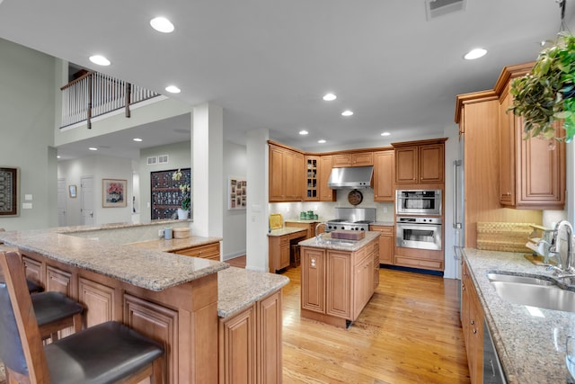 117 Morning Side Ter, East Stroudsburg, PA 18302 - kitchen featuring visible vents, a center island, under cabinet range hood, and a sink