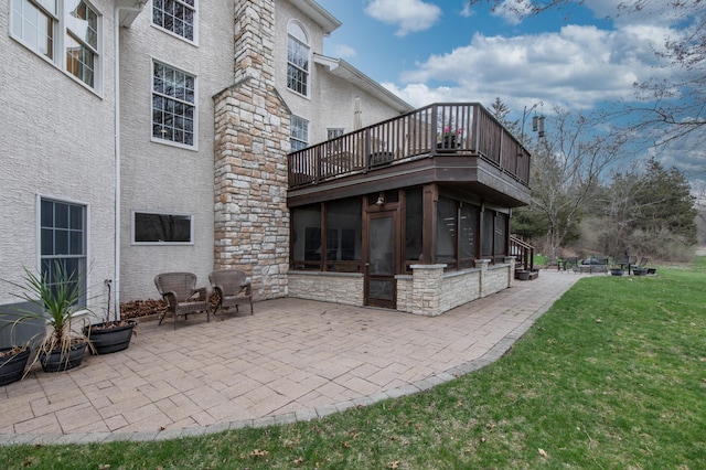 117 Morning Side Ter, East Stroudsburg, PA 18302 - rear view of house with stone siding, a lawn, a balcony, a sunroom, and a patio
