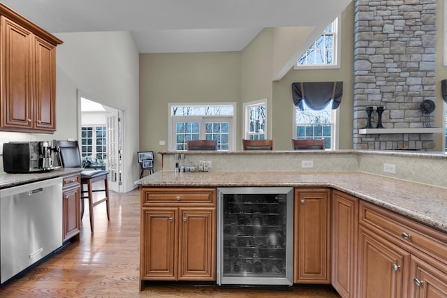 117 Morning Side Ter, East Stroudsburg, PA 18302 - kitchen with a towering ceiling, wine cooler, stainless steel dishwasher, light wood-type flooring, and tasteful backsplash
