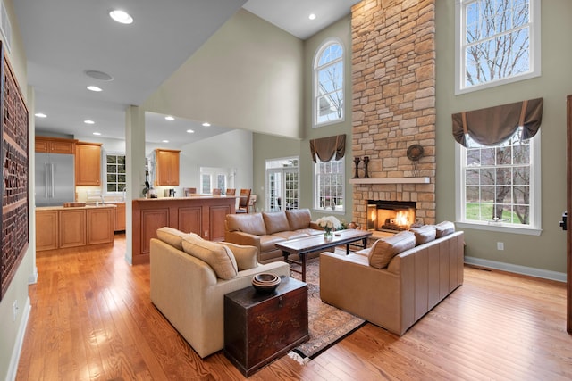 117 Morning Side Ter, East Stroudsburg, PA 18302 - living room with recessed lighting, light wood finished floors, a towering ceiling, a stone fireplace, and baseboards