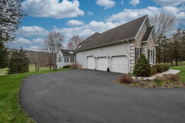 117 Morning Side Ter, East Stroudsburg, PA 18302 - view of side of property featuring driveway, stone siding, an attached garage, a yard, and stucco siding