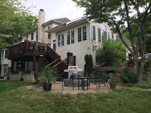 117 Morning Side Ter, East Stroudsburg, PA 18302 - rear view of property with stairway, a chimney, a wooden deck, a patio, and a lawn