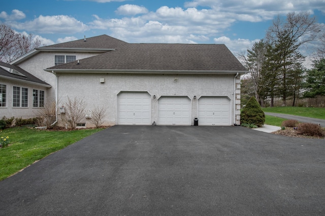 117 Morning Side Ter, East Stroudsburg, PA 18302 - view of home's exterior with a lawn, driveway, a shingled roof, an attached garage, and stucco siding