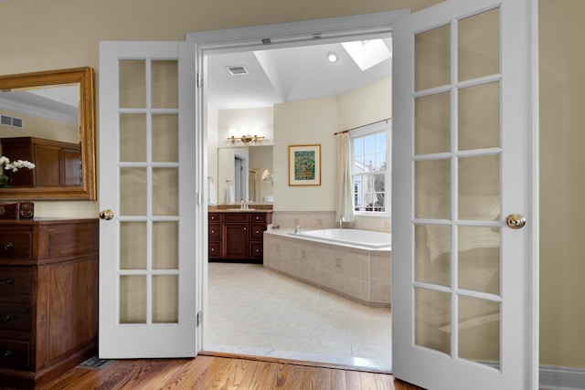 117 Morning Side Ter, East Stroudsburg, PA 18302 - full bathroom with a skylight, a bath, visible vents, and vanity