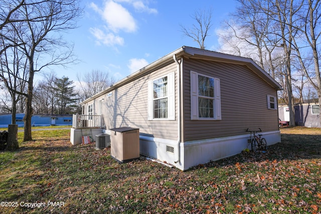 view of side of property with cooling unit