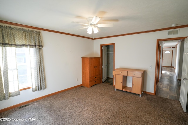 unfurnished bedroom with visible vents, baseboards, carpet, and ornamental molding