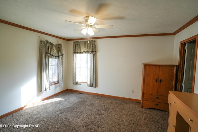 carpeted empty room featuring ceiling fan, crown molding, and baseboards