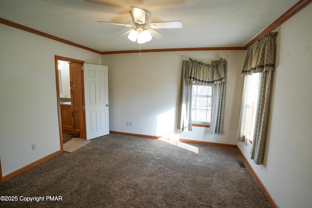 carpeted empty room with a ceiling fan, baseboards, and ornamental molding