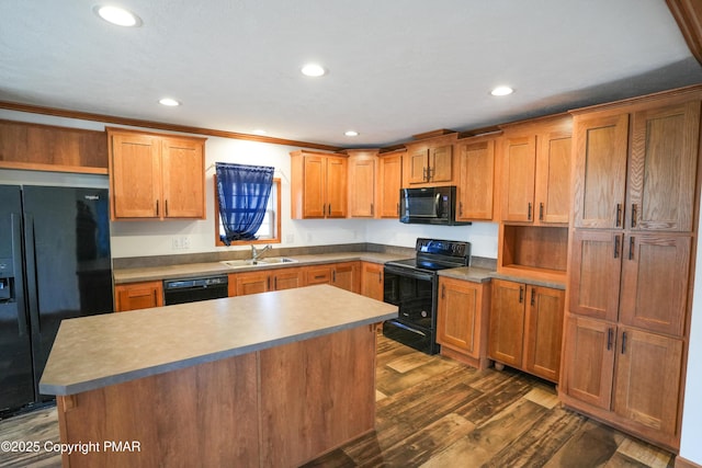 kitchen featuring black appliances, a sink, dark wood-style floors, a center island, and recessed lighting