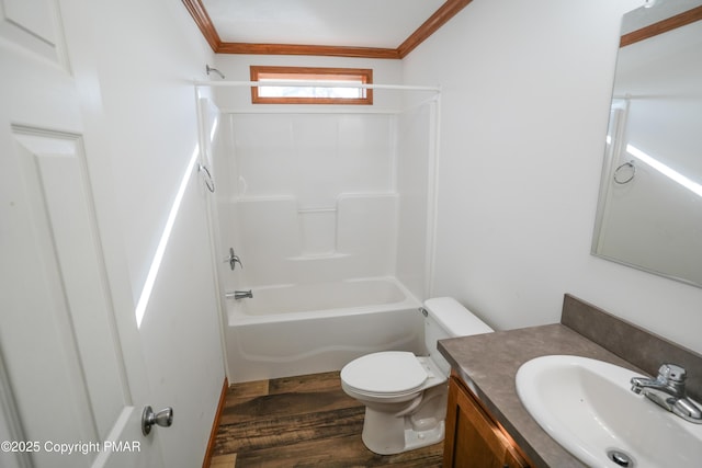 bathroom with crown molding, toilet, shower / tub combination, wood finished floors, and vanity