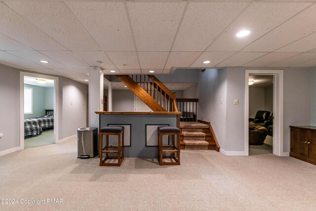 bar featuring carpet flooring, recessed lighting, stairs, and baseboards