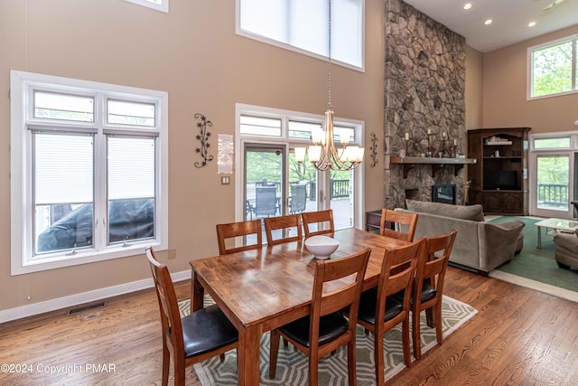 dining room with plenty of natural light, light wood-style floors, visible vents, and a chandelier