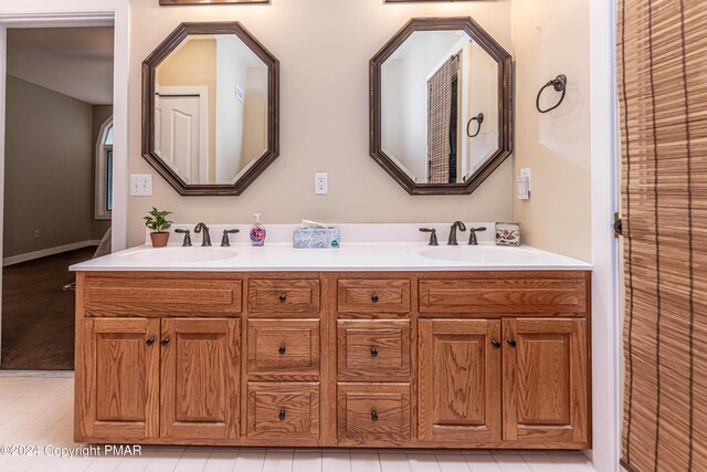 full bathroom featuring double vanity and a sink