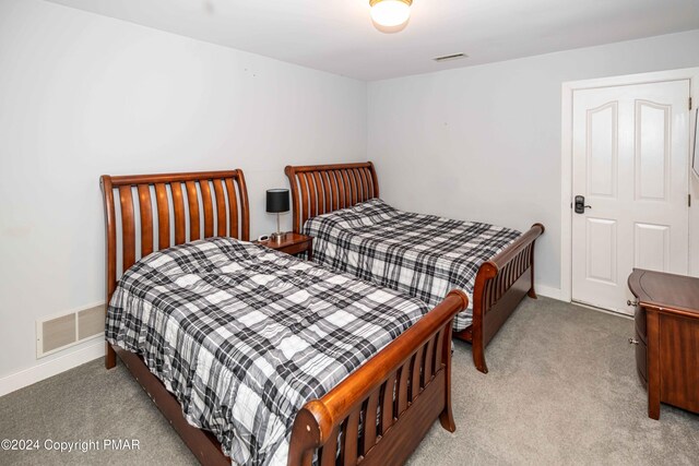 carpeted bedroom featuring baseboards and visible vents