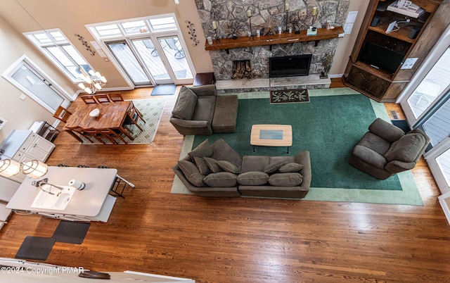 living area with a fireplace and wood finished floors