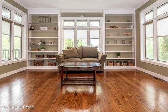 sitting room with a wealth of natural light, visible vents, dark wood-style flooring, and crown molding