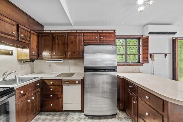 1371 Brian Ln, Effort, PA 18330 - kitchen featuring appliances with stainless steel finishes, an AC wall unit, light countertops, and a peninsula