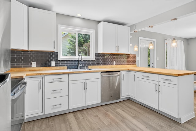 6471 Decker Rd, Bushkill, PA 18324 - kitchen with wooden counters, stainless steel appliances, a peninsula, light wood finished floors, and tasteful backsplash