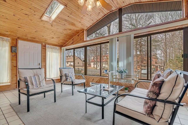 sunroom with a wealth of natural light, lofted ceiling with skylight, and a ceiling fan