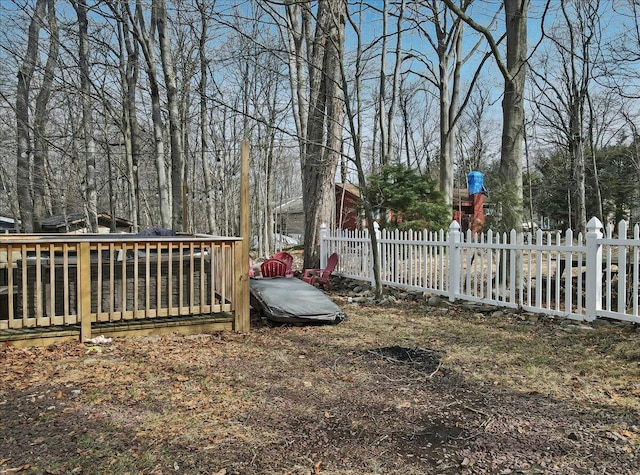 view of yard featuring a deck and fence