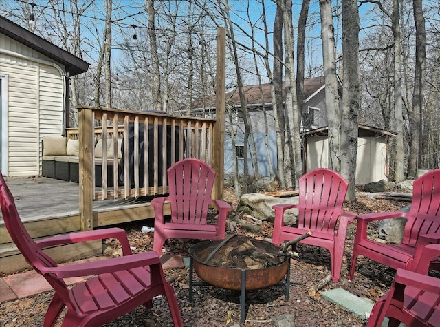 wooden terrace featuring a fire pit